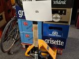 a pile of beer boxes and a bicycle in a room