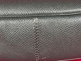 the inside of a black purse on a red surface