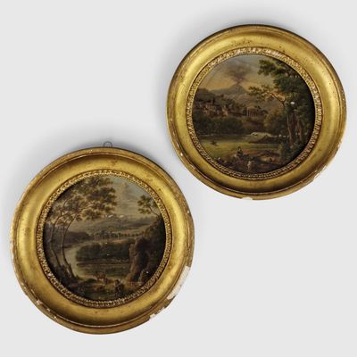 une paire de tableaux représentant un paysage, dans un cadre doré