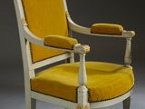 an antique chair with yellow upholstered upholstered seat