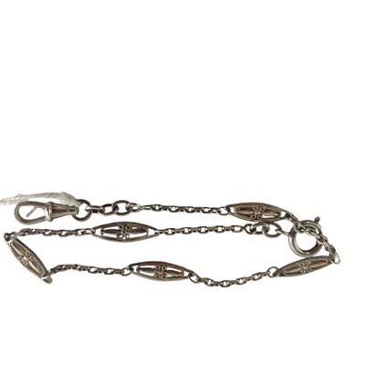 a close up of a chain bracelet with a bird on it