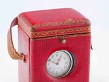 a small red box with a clock inside of it