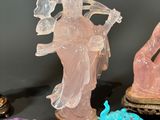 several crystal figurines are displayed on a black surface