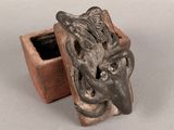an image of a clay box with a face on it