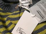 a label on a sweater with a tag attached to it