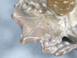 a silver figurine that is on a table