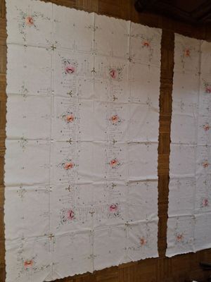 two pieces of fabric hanging on the wall next to each other