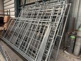a lot of metal frames that are stacked up in a warehouse