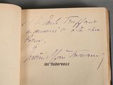 an open book with handwriting on it sitting on top of a table