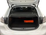 the back of a white car with its trunk open and a luggage bag in the trunk