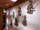 a lot of statues on the wall in the room