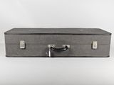 a gray suitcase sitting on a white surface