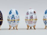 four different types of decorated eggs are lined up in a row