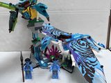a blue and green toy with a dragon on top of it