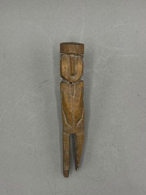 a close up of a wooden object on a white surface
