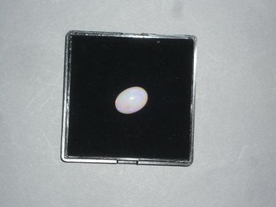 a white oplite in a black box on a white surface