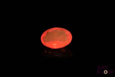 an orange light in the dark with the moon in the background
