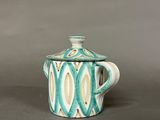 teapot with a lid in the shape of a fish on a gray background