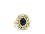 a close up of a ring with a sapphire and diamonds