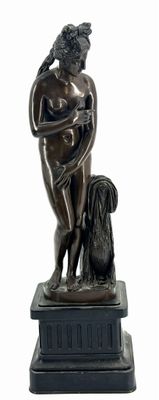 statue of a woman with a dog on a pedestal