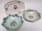 three plates that have flowers on them on them