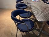 une table entourée de six chaises bleues dans une pièce