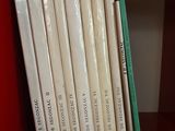 many books on a red book shelf on the shelf