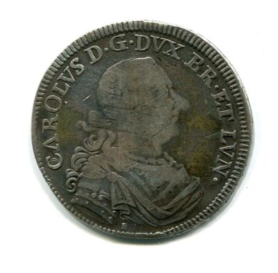 une vieille pièce de monnaie sur laquelle figure l'effigie d'un homme, sur un fond blanc