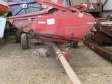 a red tractor trailer parked in a barn next to other farm equipment