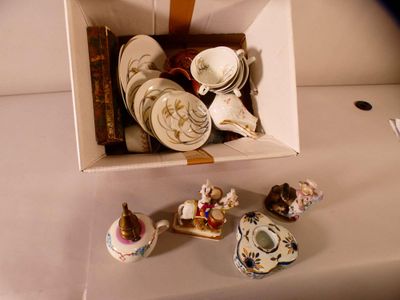 a box with a bunch of china items in it