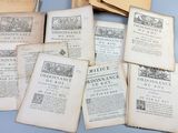 several old books sitting on top of each other on a table
