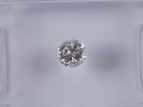 a close up of a diamond in a clear box on a white surface