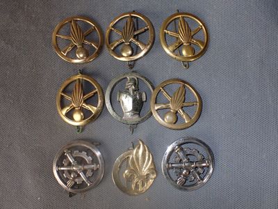 a lot of metal badges that are on a table