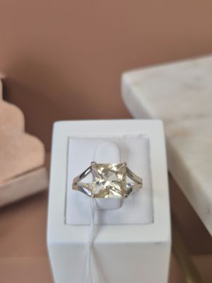 a diamond ring in a white box on a table