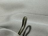 a small metal object that is laying on a piece of cloth
