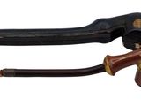 a pipe and a pipe holder sitting next to each other