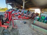 a tractor that is parked in a barn next to hay