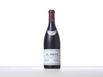 a bottle of red wine sitting on top of a table