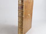 an old book sitting on top of a wooden table