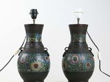 pair of asian vases with floral designs on them on a white surface