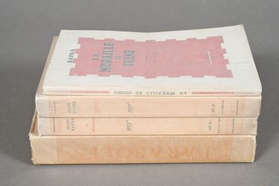 three books are stacked on top of each other on a table