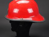 a red hard hat sitting on top of a mannequin head