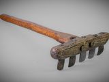 an old picker with a wooden handle on a white surface