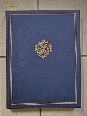 the blue book is sitting on the tiled floor next to the wall