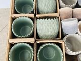 many bowls and cups in a wooden box on the floor