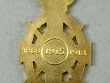 a gold medal with a red ribbon around it