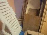 a room with a chair and boxes on the floor