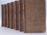 five books lined up in a row on a white surface