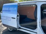 a white van with the door open on the side of the road
