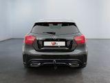 the rear end of a black mercedes cla parked in a white room